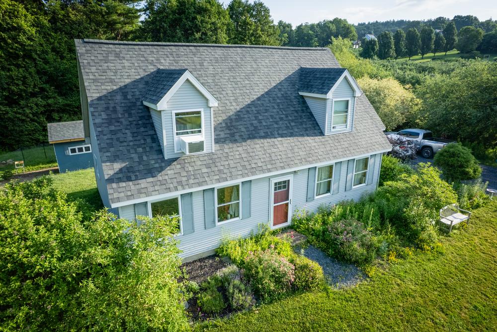 Cape-style home with dormers and a new shingle roof in Ferrisburgh, Vermont