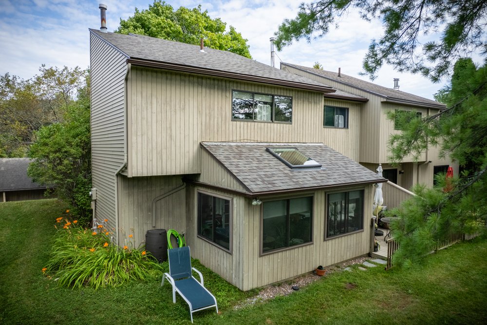 Townhome with a shingle roof and skylight in South Burlington, Vermont