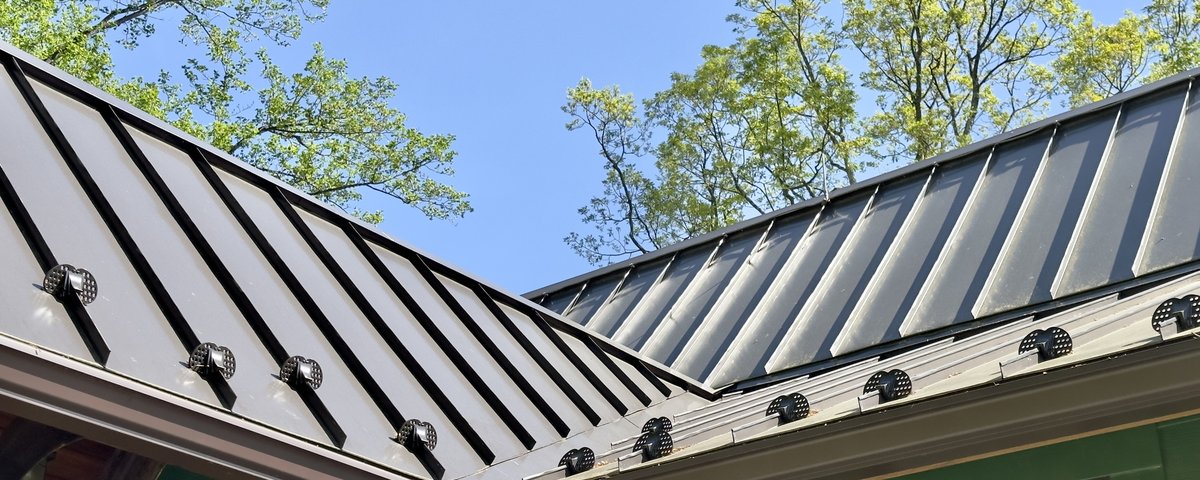 Standing seam metal roof detail — charcoal panels, Vermont home