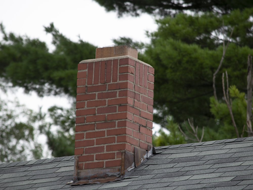 Deteriorated chimney flashing and counter flashing on a Vermont roof