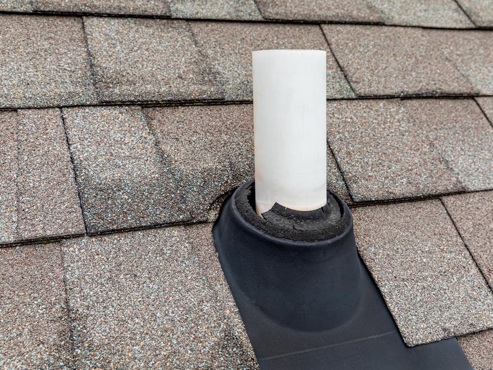 Cracked rubber pipe boot on an asphalt shingle roof