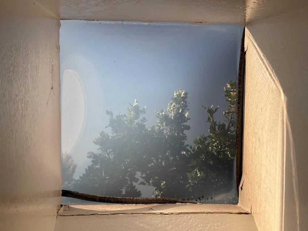 Skylight curb and flashing being repaired on a residential roof